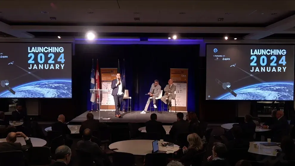 NorthStar CEO speaks on stage at the Canada-Italy Business Forum on Artificial Intelligence with audience and presentation screens.