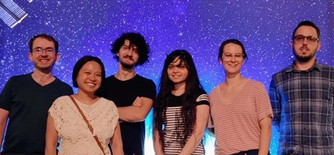 NorthStar Montreal team standing together in front of a space exhibit backdrop.