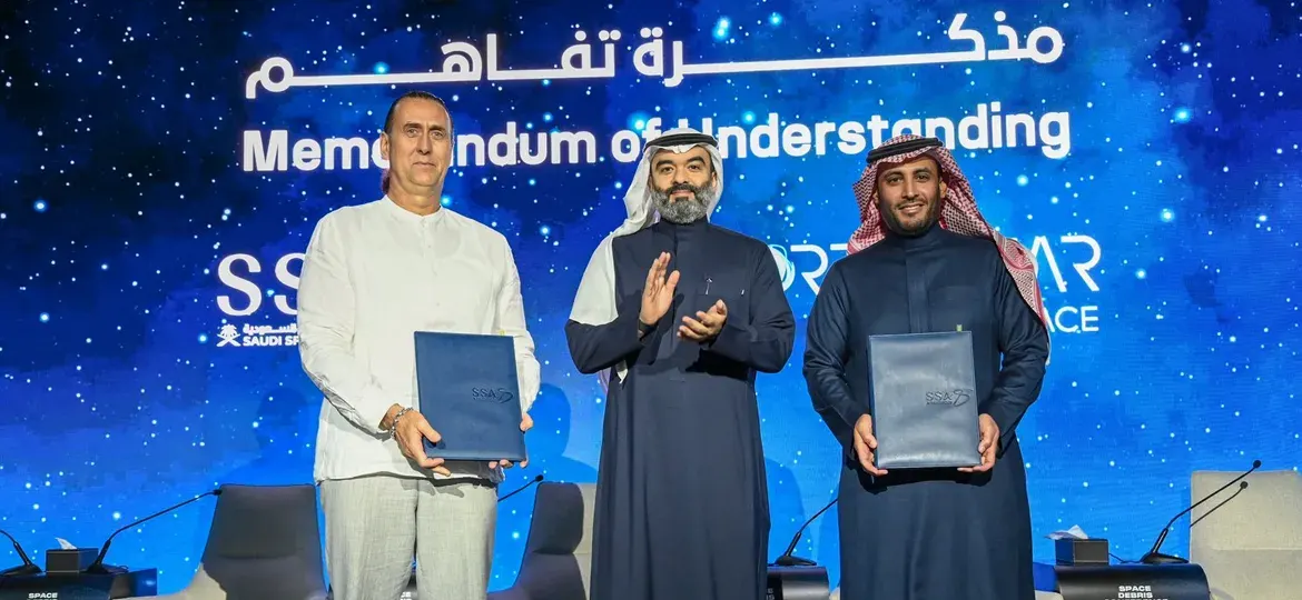 Representatives on stage holding agreement folders during the NorthStar and Saudi Space Agency MoU signing ceremony.